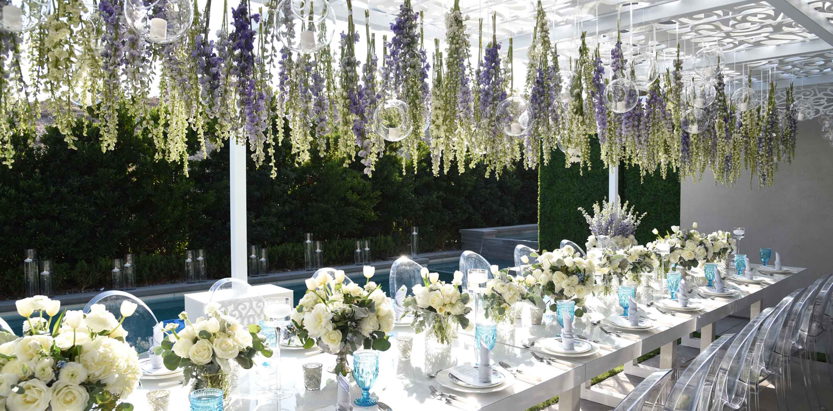 Flowers suspended over the table at an outdoor baby shower