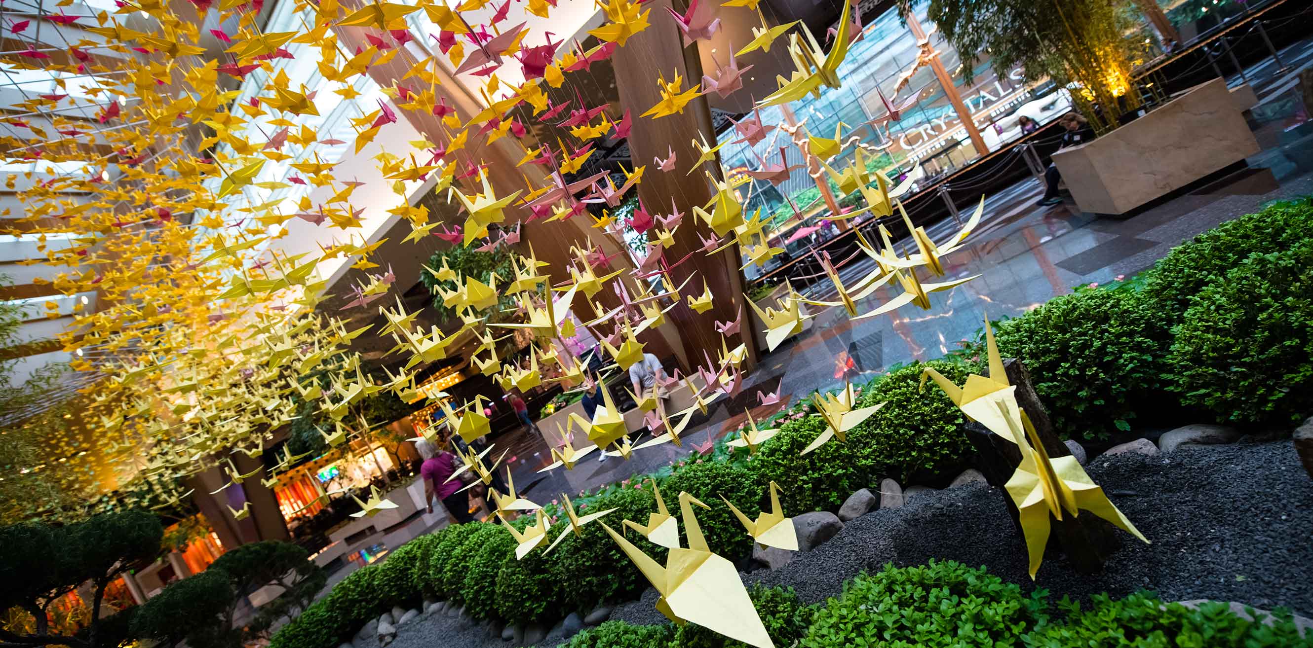 Hundreds of origami cranes arch over the Aria reception area